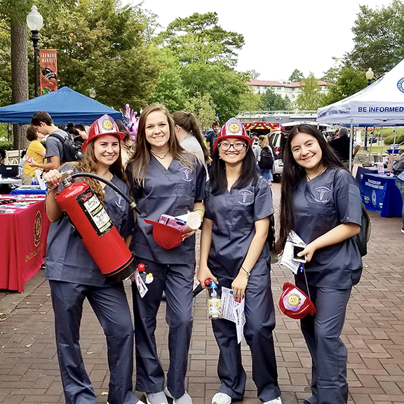 students at safety fair with fire safety materials like fire extinguisher